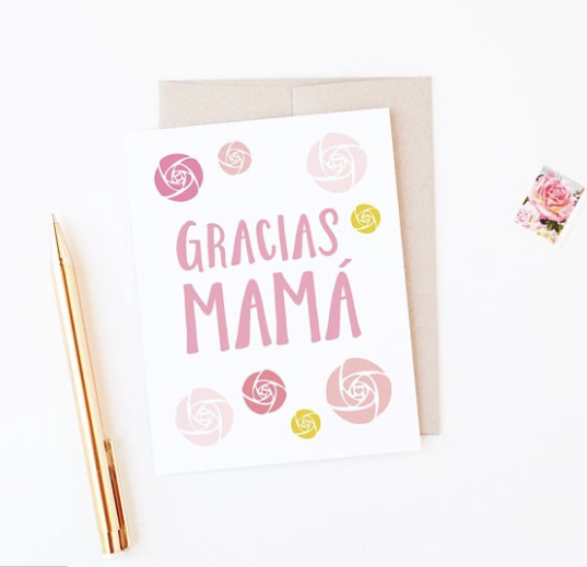 White card with various shades of flowers surrounding the words Gracias Mama.