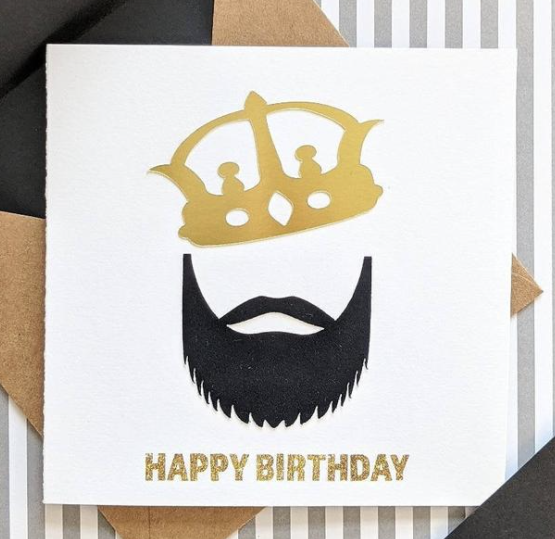 Your bearded family, friends, and baes will definitely love this card. The front features a metallic paper gold crown along with a velvet textured beard. It gets even better when you open up the card! Not only is there a wonderful message to your bearded king, there's also a definition of "King" set atop a background with mini crowns. Whoever you gift this to you will not be disappointed. 5x5 notecard with Kraft envelope
