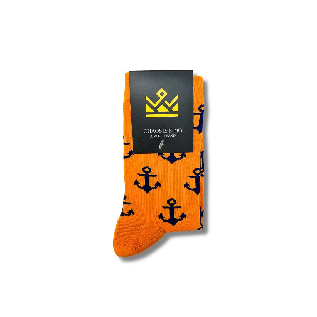 Orange men socks with a blue ship anchor pattern on them