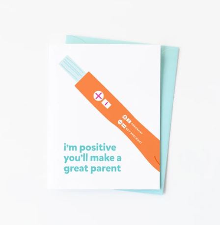 White card with a pregnancy test result showing positive and the words I'm positive you'll make a great parent written in light blue underneath. Blank inside